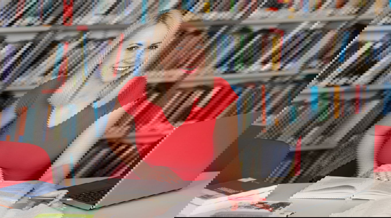 anforderungen_dissertation_doktorandin_header_iStock-1414870174.jpg Eine Doktorandin in der Bibliothek beim Schreiben der Doktorarbeit